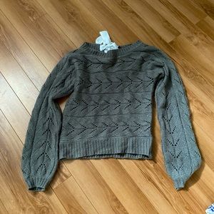 Gray pullover sweater. Very flattering ! Back of sweater tied with white ribbon.